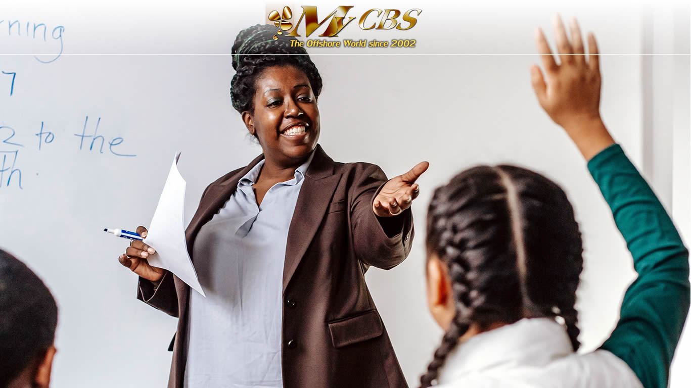 Picture of a girl raising her hand to ask a question and her teacher yielding the floor to her.